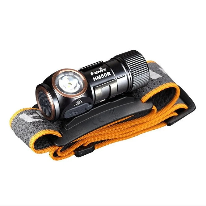 The Fenix HM50R V2.0 detached from its headband, shown as a compact right-angle flashlight with pocket clip
