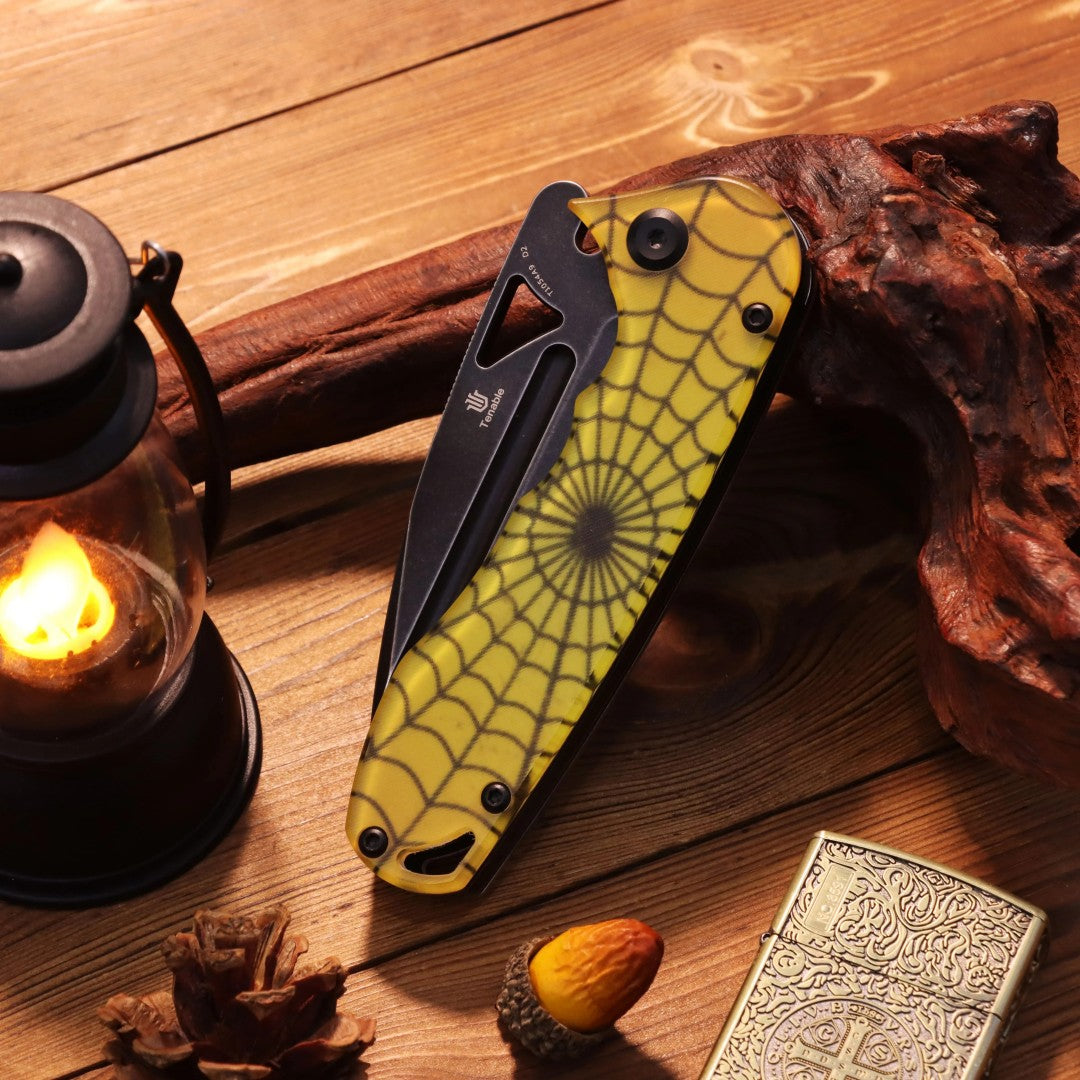 Closed rear of the Bombur T1054A9 Halloween limited edition showing pocket clip and numbered build beside lantern light
