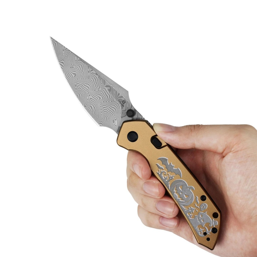 In-hand shot of the open Tenable Fenrir B1034H24 showing ergonomic golden anodized aluminum grip, studio product photo on a white background