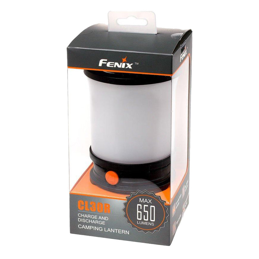 The Fenix CL30R lantern glowing on a camp table at dusk, showing its wide, even area light coverage across the whole campsite
